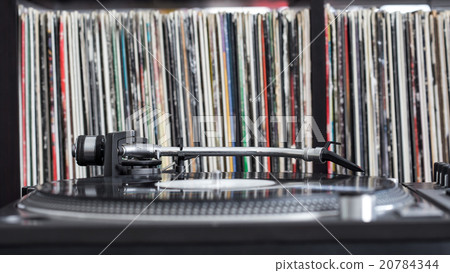 Dj turntable on vinyl background 20784344