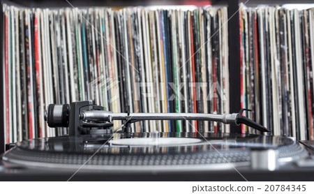 Dj turntable on vinyl background 20784345