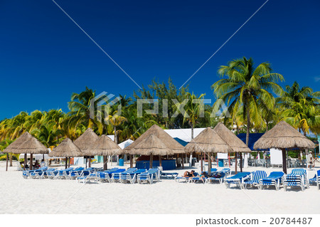 Caribbean beach with sun umbrellas and beds 20784487