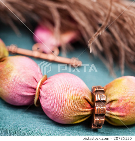 necklace from pink silk balls close up on green 20785130