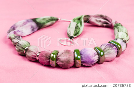 necklace from silk balls and ceramic rings on pink 20786788
