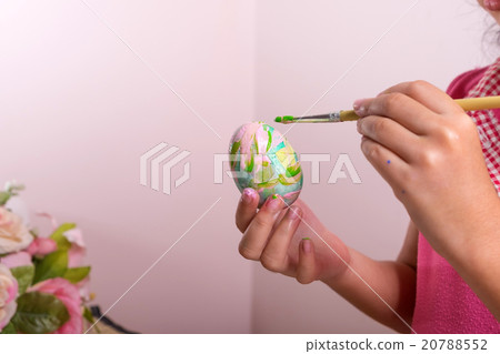 Child is painting fake egg 20788552