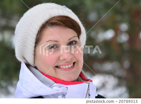 woman in sports jacket and hat at  winter pine forest  20789313