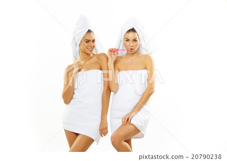 Two girls brush their teeth after shower Two girls brush their teeth after shower 20790238