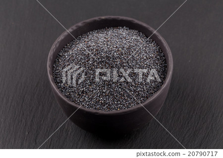 poppy seeds in a stone bowl 20790717