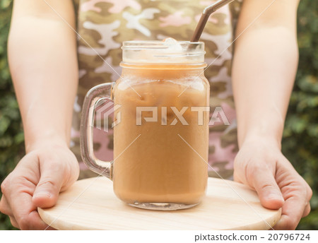 Hand hold glass of iced coffee with vintage filter 20796724