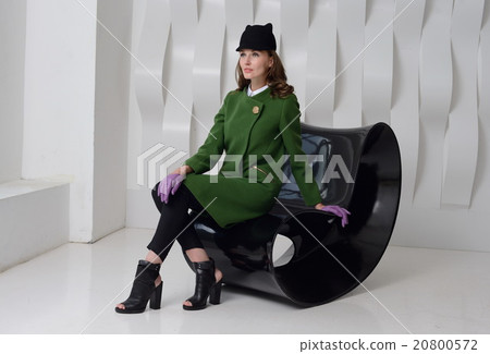 Girl in studio posing at coat Girl in studio posing at coat 20800572
