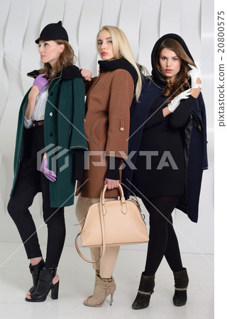 Girls in studio posing at coats Girls in studio posing at coats 20800575
