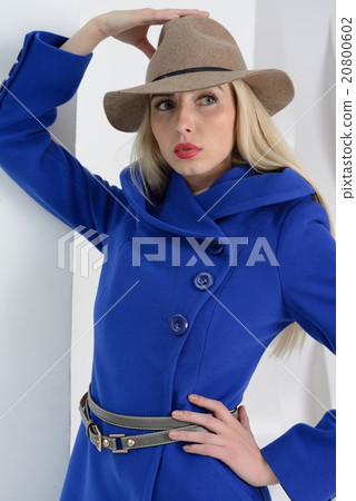 Girl in studio posing at coat Girl in studio posing at coat 20800602
