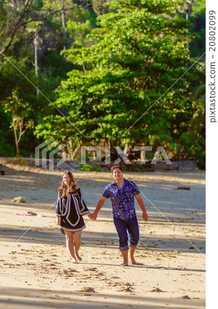 Honeymoon couple playing on a beach in Thailand Honeymoon couple playing on a beach in Thailand 20802099