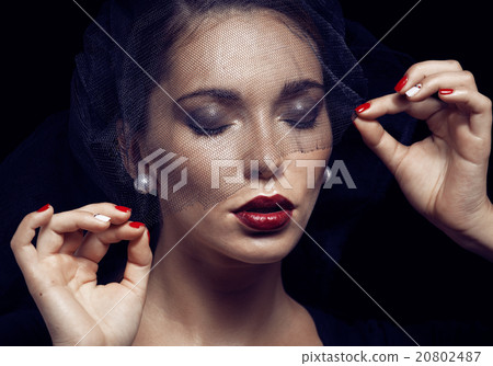 beauty brunette woman under black veil with red 20802487