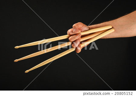 Wolverine hand with three drumsticks over black Wolverine hand with three drumsticks over black 20805152