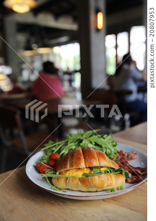 croissant with egg and bacon on wood background 20807953