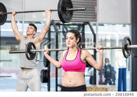 Fit couple lifting barbell Fit couple lifting barbell 20818848