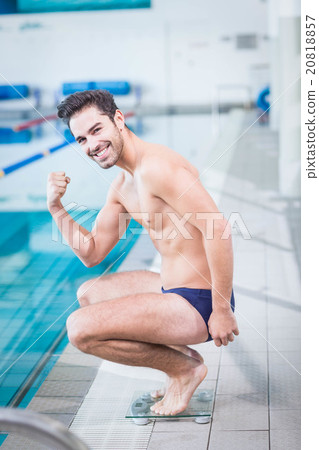 Fit man triumphing on the weighting scale Fit man triumphing on the weighting scale 20818857