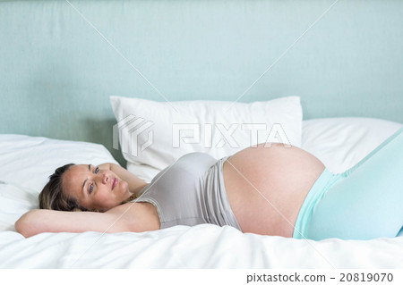 Pregnant woman lying on her bead 20819070