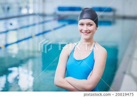 Cute woman wearing swim cap with arms crossed Cute woman wearing swim cap with arms crossed 20819475