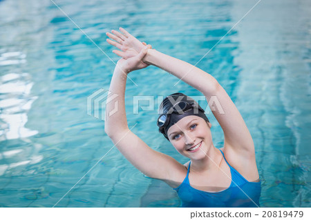 Fit woman stretching in the water Fit woman stretching in the water 20819479