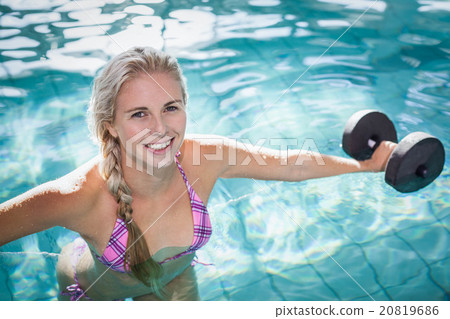 Attractive woman lifting dumbbells 20819686