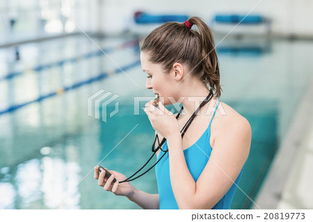 Pretty trainer blowing whistle and looking at stopwatch 20819773