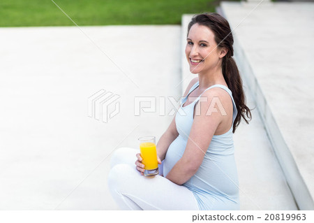 Pregnant woman sitting on stairs Pregnant woman sitting on stairs 20819963
