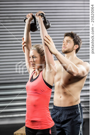 Couple exercising with dumbbells Couple exercising with dumbbells 20820064