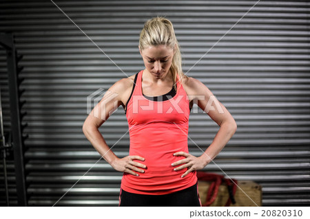 Woman posing with hands on hips Woman posing with hands on hips 20820310