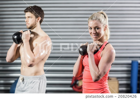 Couple lifting dumbbells together Couple lifting dumbbells together 20820426