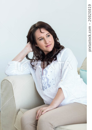 Pregnant woman sitting in the living room 20820819