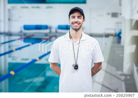 Handsome trainer standing with hands on the back Handsome trainer standing with hands on the back 20820907