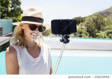 Beautiful blonde taking selfie 20820949