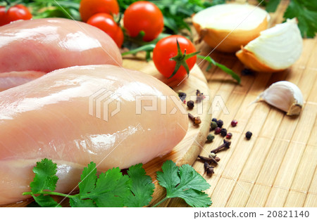 Raw chicken fillet with vegetables and spices. Raw chicken fillet with vegetables and spices. 20821140