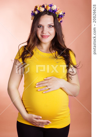 Happy pregnant girl with wreath of flowers Happy pregnant girl with wreath of flowers 20826628