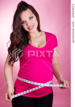 Happy pregnant girl with tape measure Happy pregnant girl with tape measure 20826631