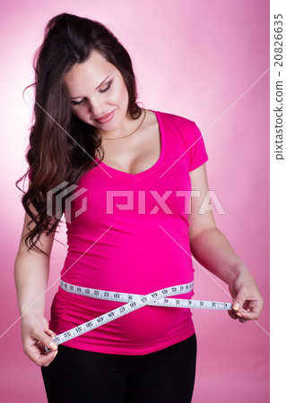 Happy pregnant girl with tape measure Happy pregnant girl with tape measure 20826635