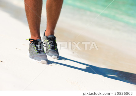 Young male runner getting ready to start on white 20826863