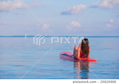 Beautiful surfer woman surfing in turquoise sea Beautiful surfer woman surfing in turquoise sea 20826906