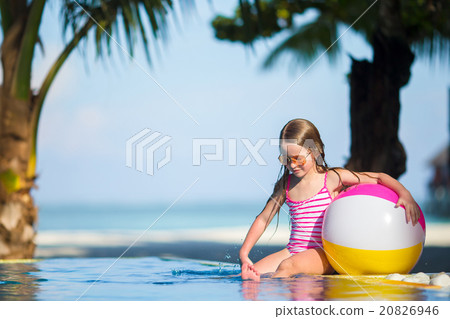 Smiling adorable girl playing with inflatable toy Smiling adorable girl playing with inflatable toy 20826946