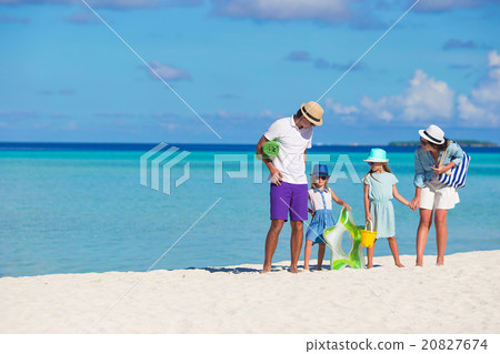 Happy beautiful family on white beach during 20827674