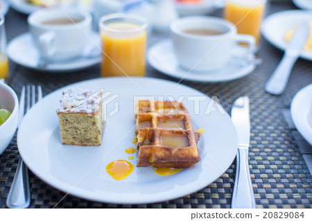 Delicious waffles, cake, coffee and juice served Delicious waffles, cake, coffee and juice served 20829084