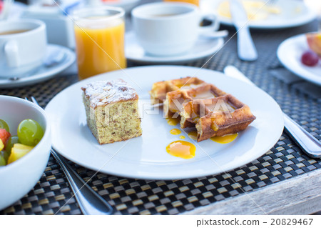 Delicious waffles, cake, coffee and juice served Delicious waffles, cake, coffee and juice served 20829467