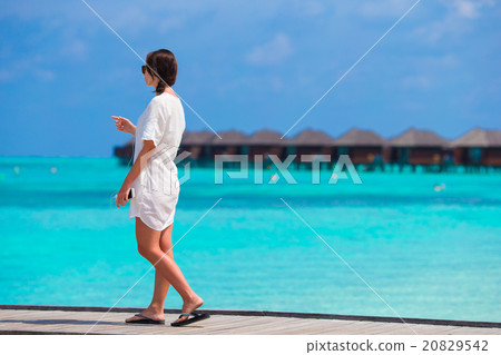 Young beautiful girl listening to music on a 20829542