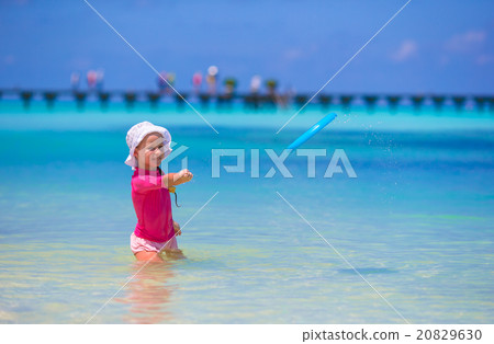 Little girl playing with flying disc at wnite Little girl playing with flying disc at wnite 20829630