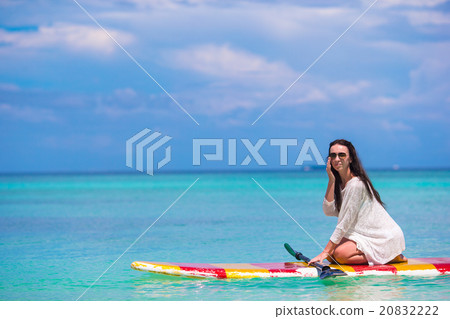Active young woman on stand up paddle board Active young woman on stand up paddle board 20832222