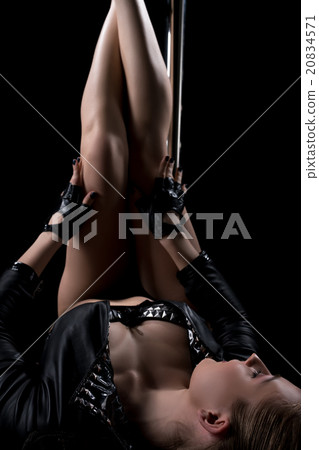 Image of dancer stretched out her legs to pylon Image of dancer stretched out her legs to pylon 20834571