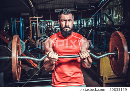 bodybuilder doing exercises with dumbbells bodybuilder doing exercises with dumbbells 20835159
