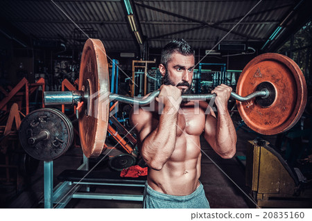 bodybuilder doing exercises with dumbbells 20835160