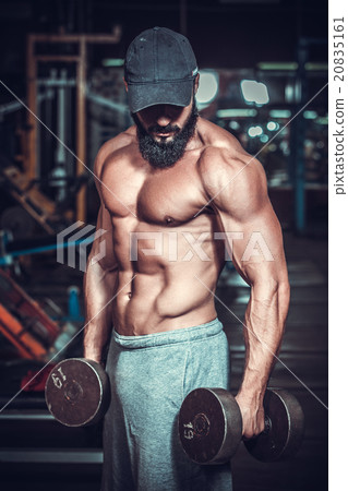 bodybuilder doing exercises with dumbbells 20835161