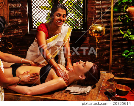 Woman having Ayurvedic spa treatment. Woman having Ayurvedic spa treatment. 20835614