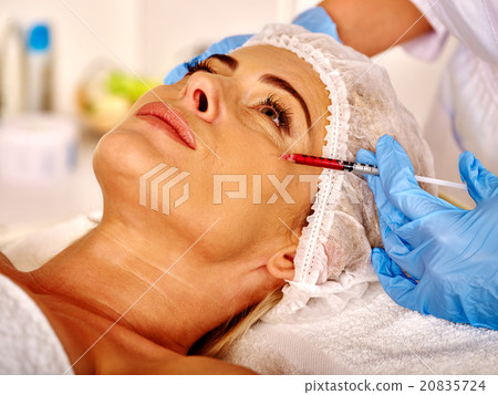Woman middle-aged in spa salon with beautician 20835724